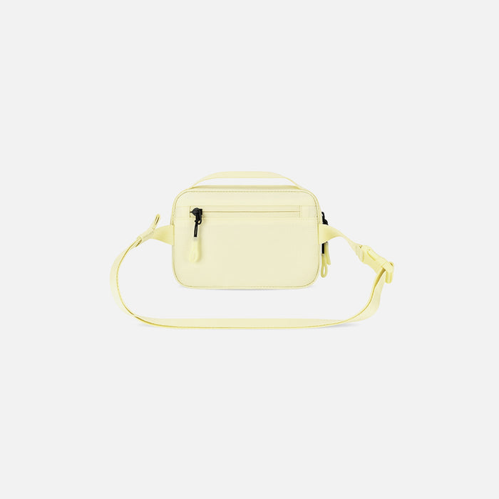 A Sherpani Hyk Sol Yellow Hip Pack, back view showing pocket and straps on white backdrop. #color_sol-yellow
