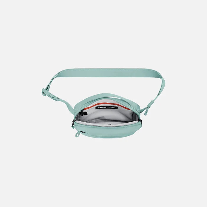 A Sherpani Hyk Surf Blue Hip Pack, above view showing inside of main pocket on white backdrop. #color_surf-blue