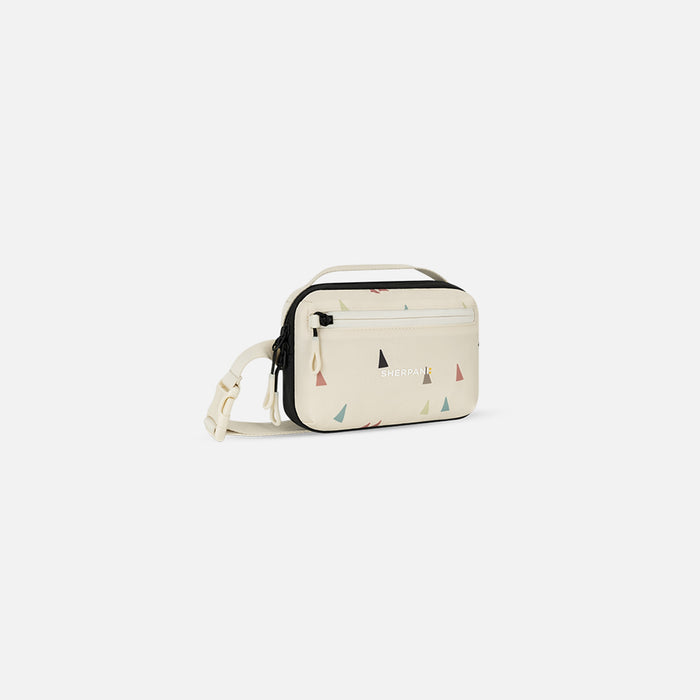 A Sherpani Hyk Terrazzo Print Hip Pack, 3/4 view showing pocket and straps on white backdrop. #color_terrazzo-print