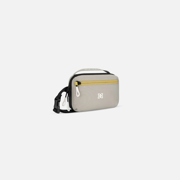 A Sherpani Hyk Wasabi Stone  Hip Pack, 3/4 view showing pocket and straps on white backdrop. #color_wasabi-stone-heritage