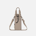 A Sherpani Izzie Dune Water Bottle Crossbody, front view showing strap and front pocket on white background.  #color_dune-tan