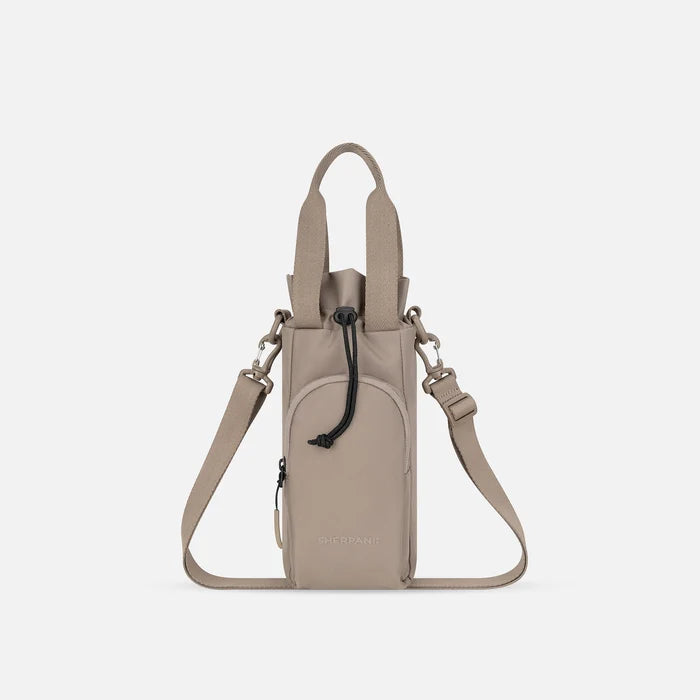 A Sherpani Izzie Dune Water Bottle Crossbody, front view showing strap and front pocket on white background.  #color_dune-tan