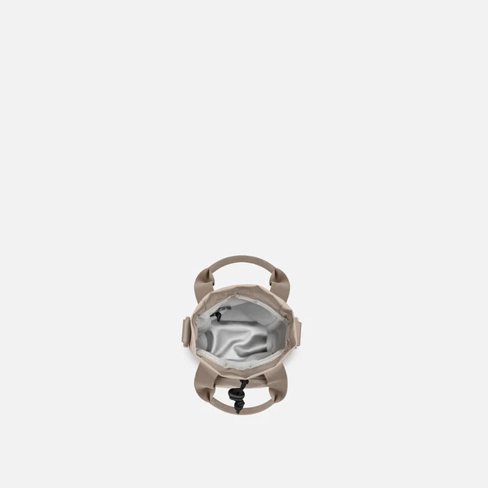 A Sherpani Izzie Dune Water Bottle Crossbody, above view showing inside water bottle holder on white background. #color_dune-tan