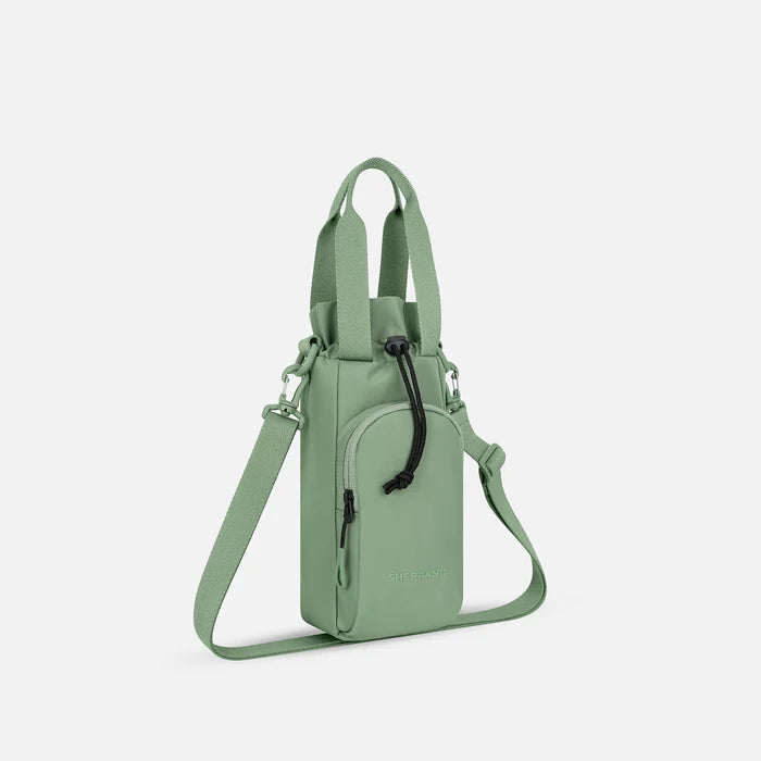 A Sherpani Izzie Olivine Water Bottle Crossbody, 3/4 view showing strap and front pocket on white background.  #color_olivine-green