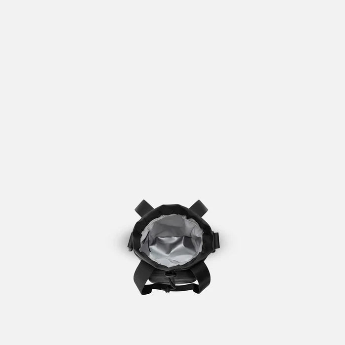 A Sherpani Izzie Raven Black Water Bottle Crossbody, above view showing inside water bottle holder on white background.  #color_raven-black