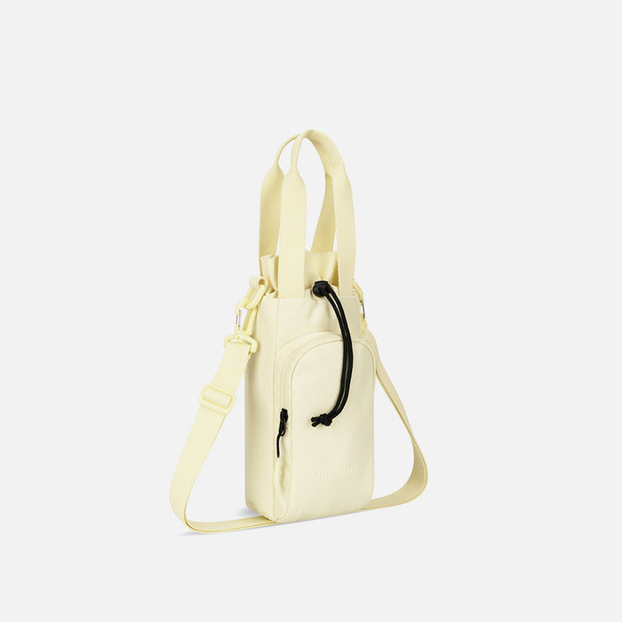 A Sherpani Izzie Sol Yellow Water Bottle Crossbody, 3/4 view showing strap and front pocket on white background.  #color_sol-yellow