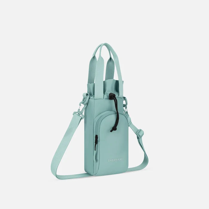 A Sherpani Izzie Surf Blue Water Bottle Crossbody, 3/4 view showing strap and front pocket on white background.  #color_surf-blue