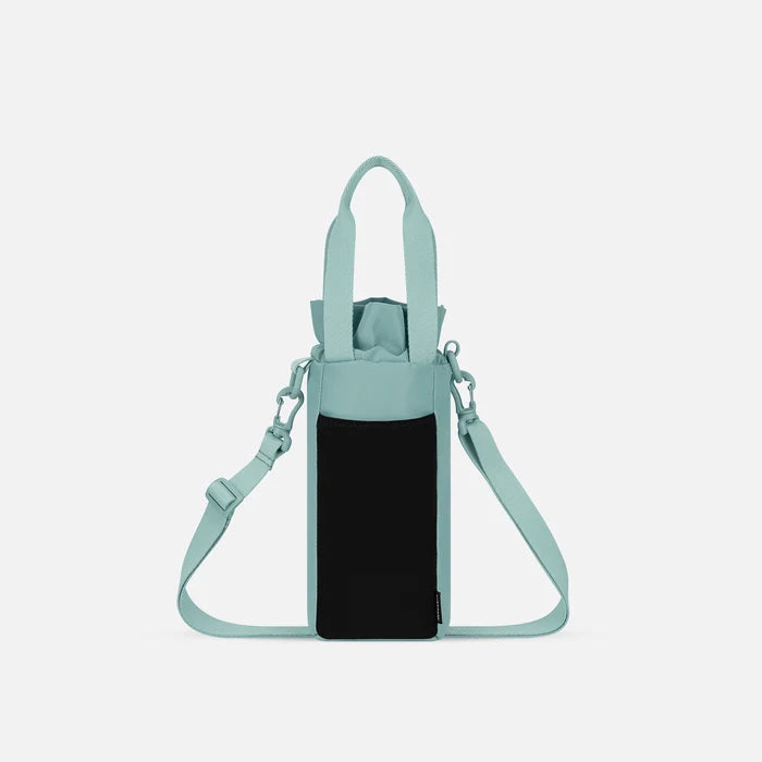 A Sherpani Izzie Surf Blue Water Bottle Crossbody, back view showing strap and back pocket on white background.   #color_surf-blue