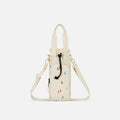 A Sherpani Izzie Terrazzo Print Water Bottle Crossbody, front view showing strap and front pocket on white background.  #color_terrazzo-print