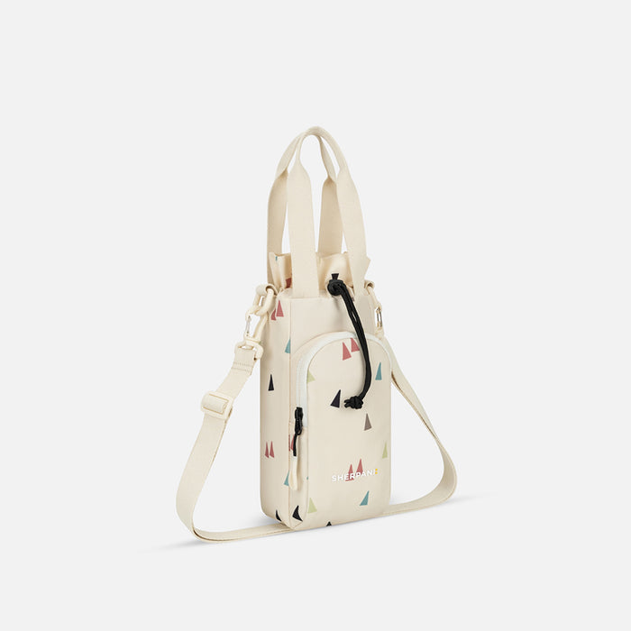 A Sherpani Izzie Terrazzo Print Water Bottle Crossbody, 3/4 view showing strap and front pocket on white background.  #color_terrazzo-print
