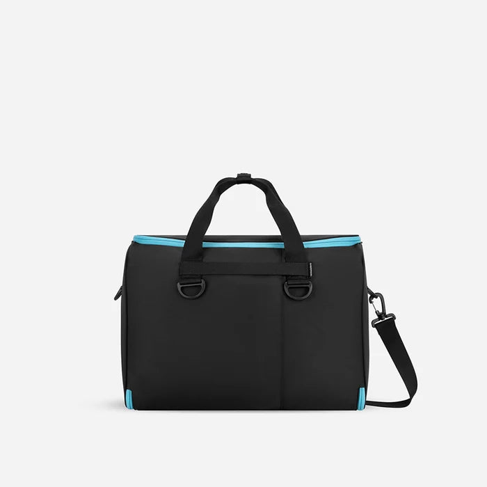 A Sherpani Jaunt Chromatic Black Garment Duffle, back view showing straps & luggage strap on white backdrop.     #color_chromatic-black