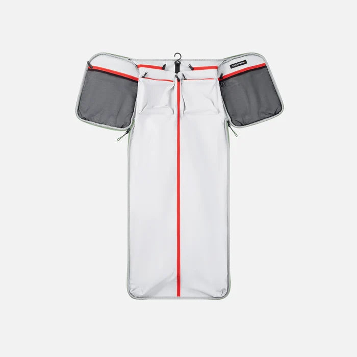 A Sherpani Jaunt Olivine Garment Duffle, above unzipped view showing foldable packing pockets on white backdrop. #color_olivine-green