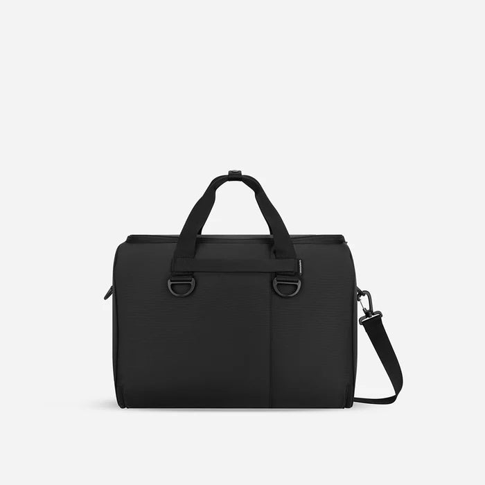 A Sherpani Jaunt Raven Black Garment Duffle, back view showing straps & luggage strap on white backdrop.    #color_raven-black