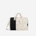 A Sherpani Jaunt Terrazzo Print Garment Duffle, front view showing straps & lockable pocket on white backdrop.  #color_terrazzo-print