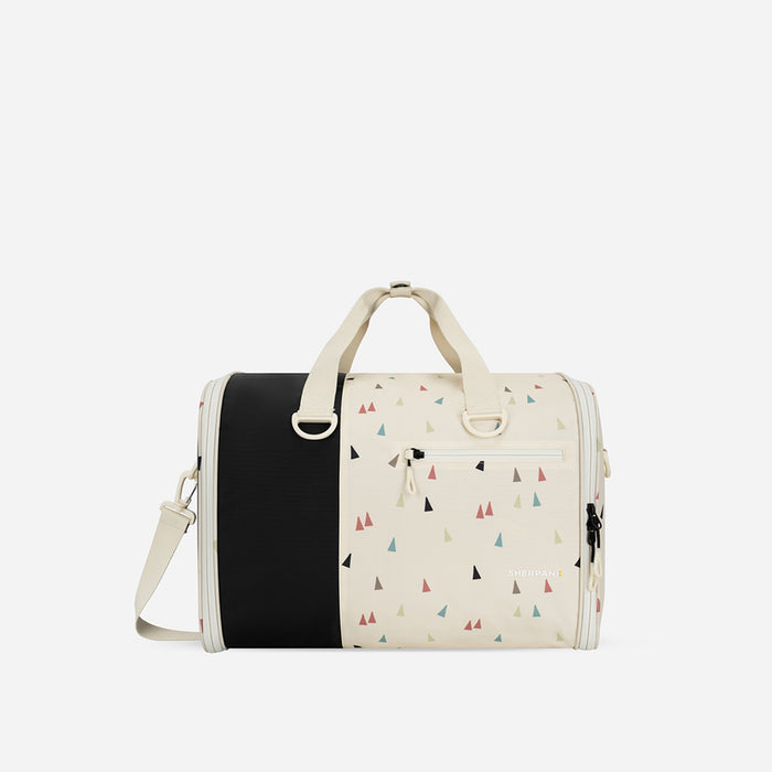 A Sherpani Jaunt Terrazzo Print Garment Duffle, front view showing straps & lockable pocket on white backdrop.  #color_terrazzo-print