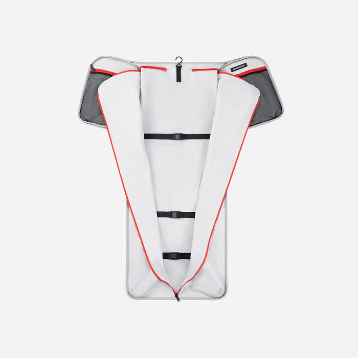 A Sherpani Jaunt Terrazzo Print Garment Duffle, above unzipped view showing foldable packing pockets on white backdrop. #color_terrazzo-print