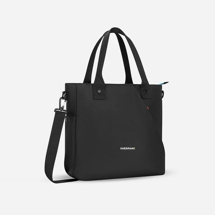 A Sherpani Jetsetter Raven Black Travel Tote Bag, 3/4 view showing two strap options on white backdrop.  #color_chromatic-black