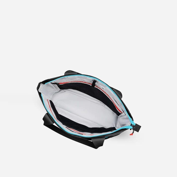 A Sherpani Jetsetter Chromatic Black Travel Tote Bag, above view showing inside pockets on white backdrop.  #color_chromatic-black