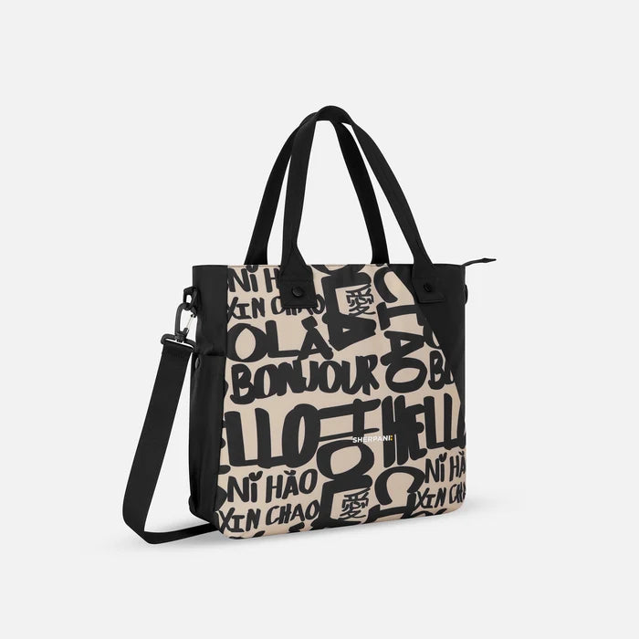 A Sherpani Jetsetter Ciao Travel Tote Bag, 3/4 view showing two strap options on white backdrop. #color_ciao-print