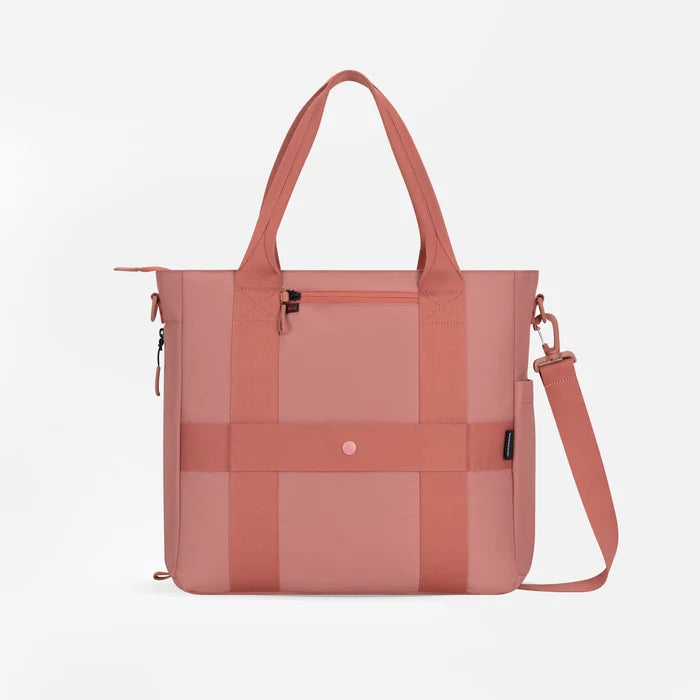 A Sherpani Jetsetter Desert Pink Travel Tote Bag, back view showing luggage strap and RFID pocket on white backdrop.   #color_desert-pink