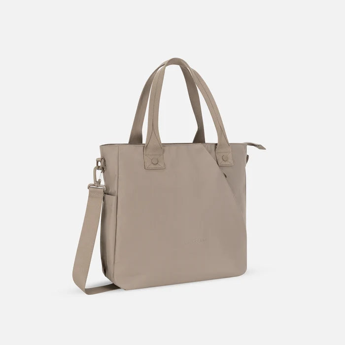 A Sherpani Jetsetter Dune Travel Tote Bag, 3/4 view showing two strap options on white backdrop. #color_dune-tan
