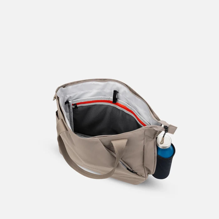 A Sherpani Jetsetter Dune Travel Tote Bag, above view showing inside pockets on white backdrop.  #color_dune-tan
