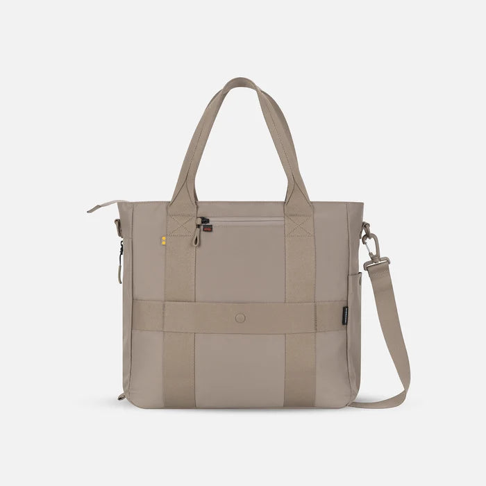 A Sherpani Jetsetter Dune Travel Tote Bag, back view showing luggage strap and RFID pocket on white backdrop.   #color_dune-tan