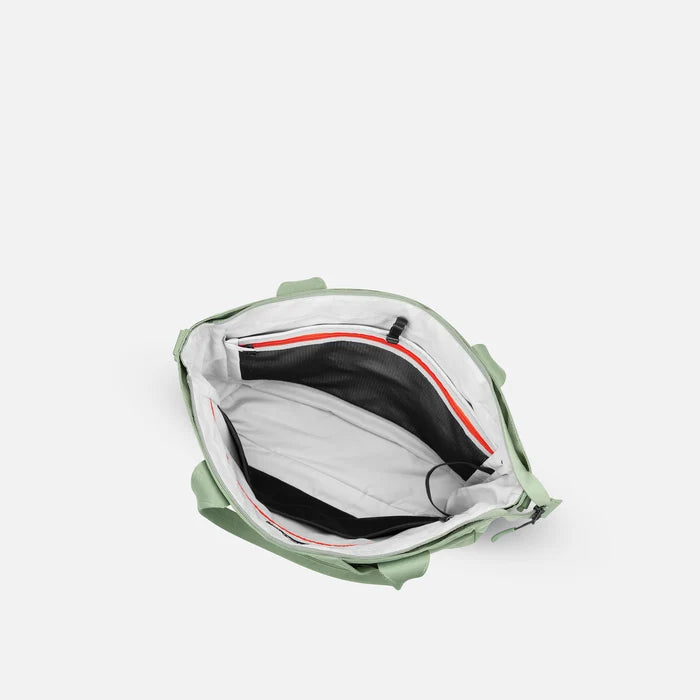 A Sherpani Jetsetter Olivine Travel Tote Bag, above view showing inside pockets on white backdrop. #color_olivine-green