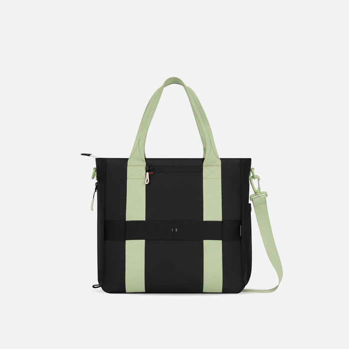 A Sherpani Jetsetter Palm Green Travel Tote Bag, back view showing luggage strap and RFID pocket on white backdrop. #color_palm-green