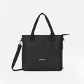 A Sherpani Jetsetter Raven Black Travel Tote Bag, front view showing two strap options on white backdrop. #color_raven-black