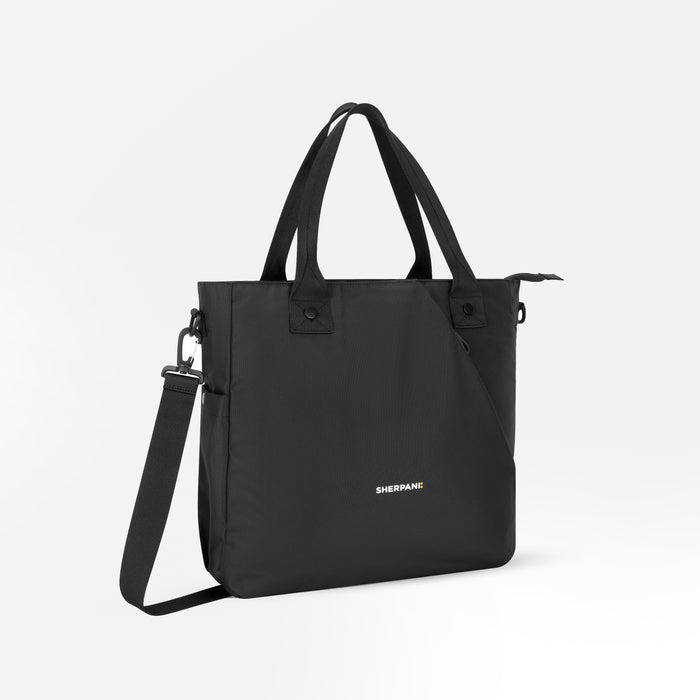 A Sherpani Jetsetter Raven Black Travel Tote Bag, 3/4 view showing two strap options on white backdrop. #color_raven-black