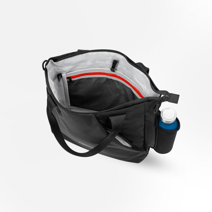A Sherpani Jetsetter Raven Black Travel Tote Bag, above view showing inside pockets on white backdrop. #color_raven-black