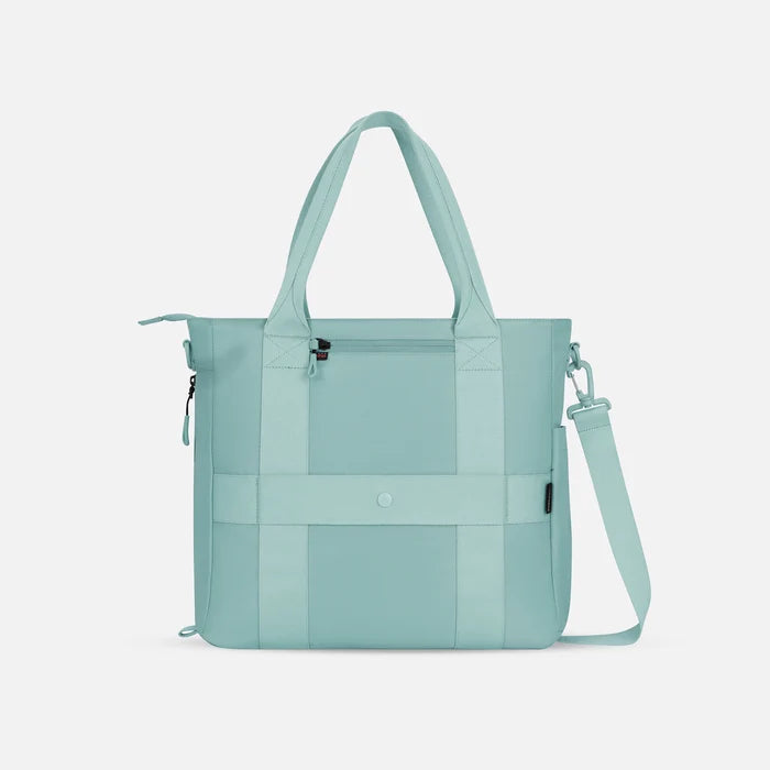 A Sherpani Jetsetter Surf Blue Travel Tote Bag, back view showing luggage strap and RFID pocket on white backdrop.  #color_surf-blue