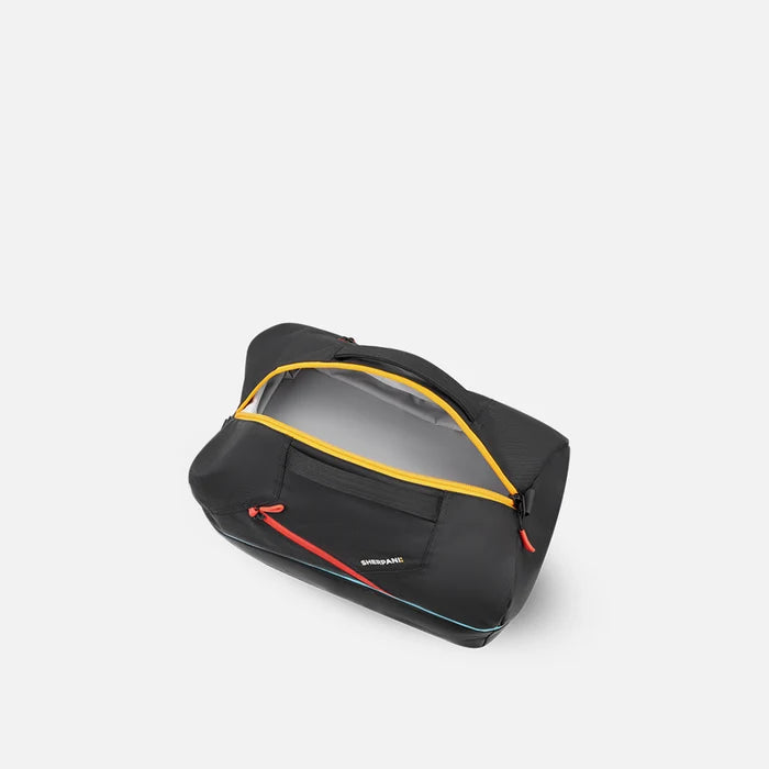 A Sherpani Juno Chromatic Black Duffel Backpack, above view showing inside main duffle pocket on white backdrop.    #color_chromatic-black