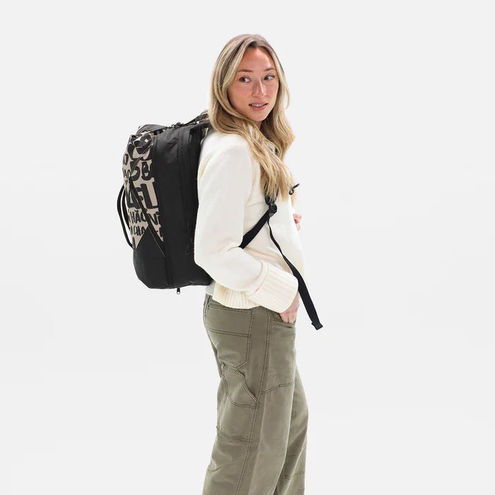 Woman wearing a Sherpani Juno Ciao Print Duffel Backpack on her back against white backdrop. #color_ciao-print