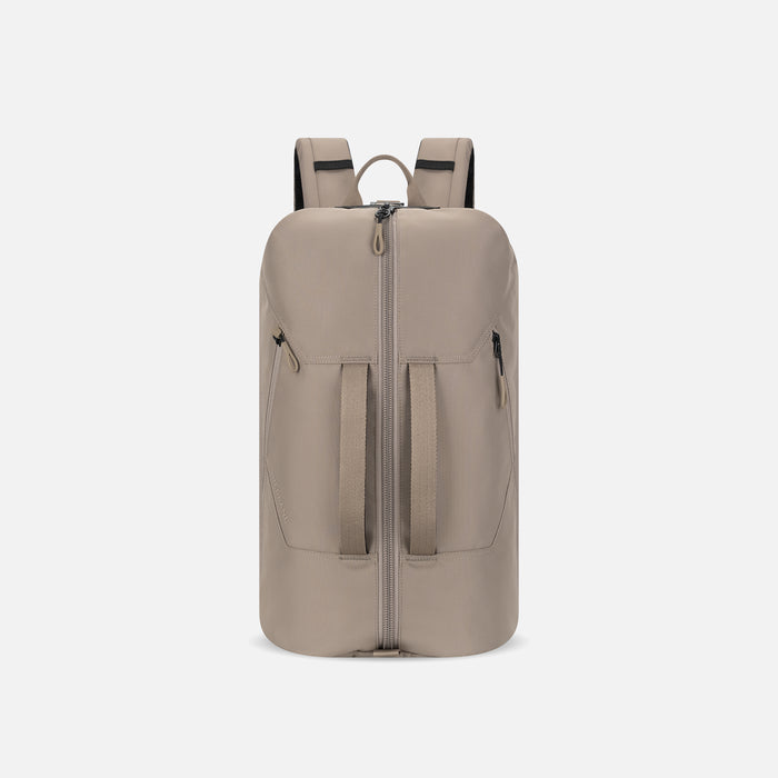 A Sherpani Juno Dune Duffel Backpack, front view showing duffle straps and main pocket on white backdrop. #color_dune-tan