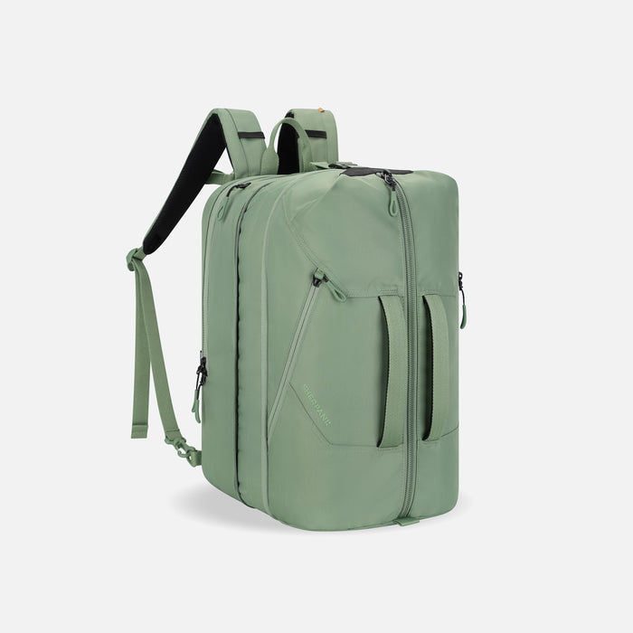 A Sherpani Juno Olivine Duffel Backpack, 3/4 view showing duffle straps and main pocket on white backdrop.   #color_olivine-green
