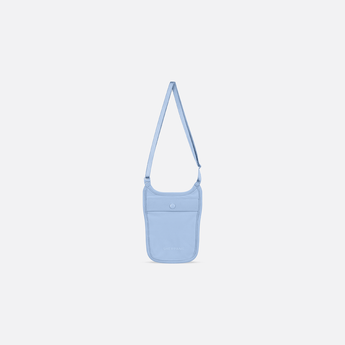 A Sherpani Soft Touch Concealed Neck Wallet, front view showing front pocket & adjustable strap against white background.