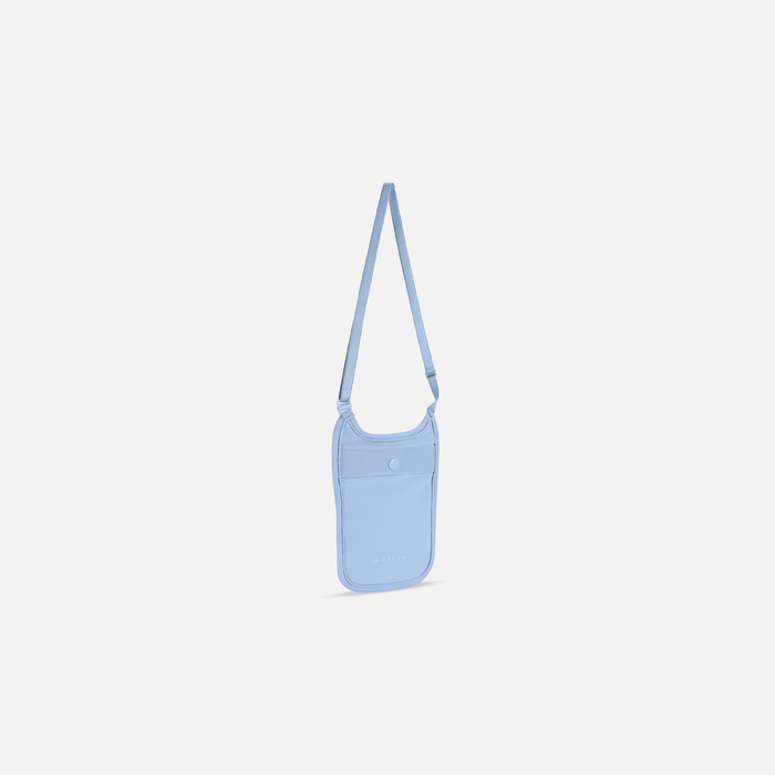 A Sherpani Soft Touch Concealed Neck Wallet, 3/4 view showing front pocket & adjustable strap against white background.