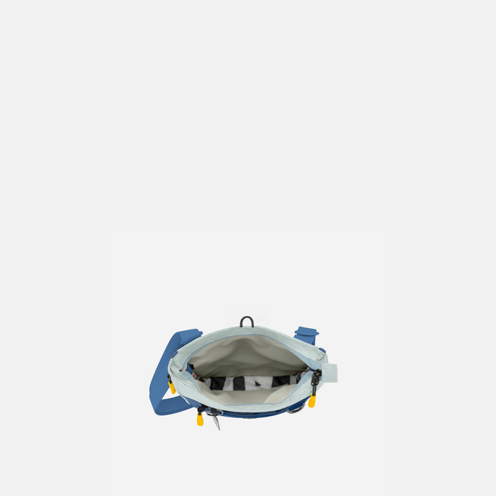 A Sherpani Lima Seastone Crossbody Purse, above view showing inside main pocket on white backdrop.    #color_seastone