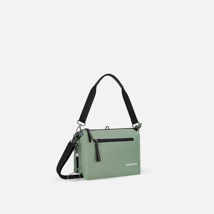A Sherpani Mei Aloe Mist Green Anti-theft Travel Trio Crossbody, 3/4 view showing three main pockets on white backdrop. #color_aloe-mist-green