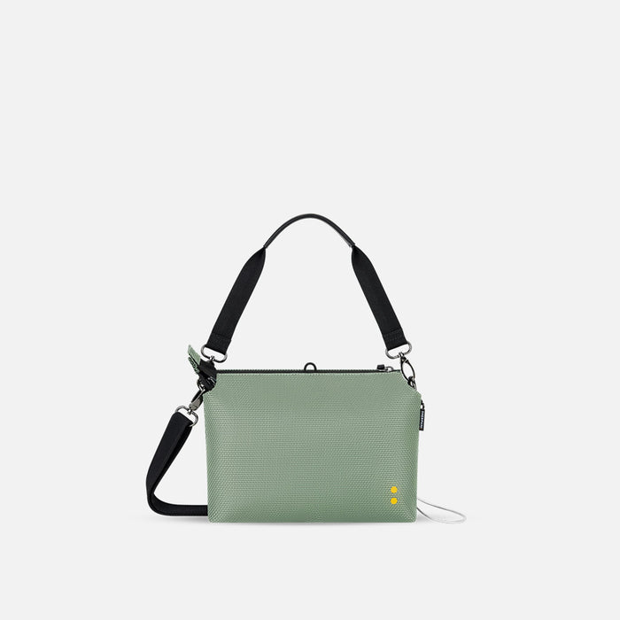 A Sherpani Mei Aloe Mist Green Anti-theft Travel Trio Crossbody, back view showing strap options on white backdrop. #color_aloe-mist-green