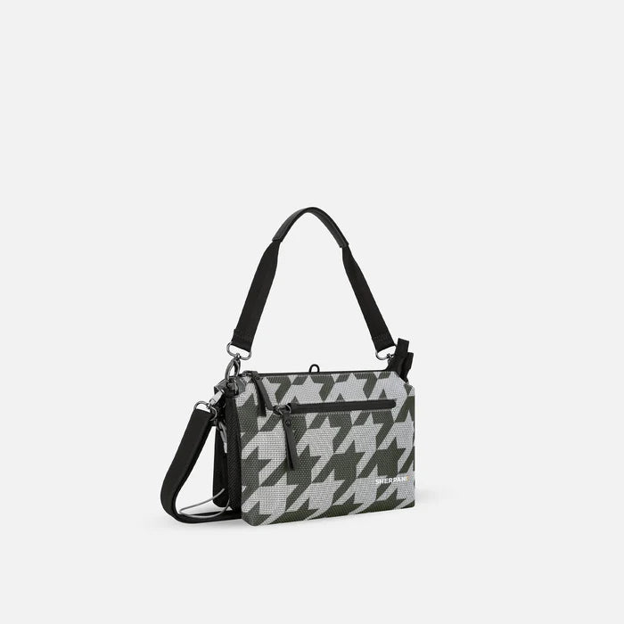 A Sherpani Mei Houndstooth Anti-theft Travel Trio Crossbody, 3/4 view showing three main pockets on white backdrop.  #color_houndstooth-print