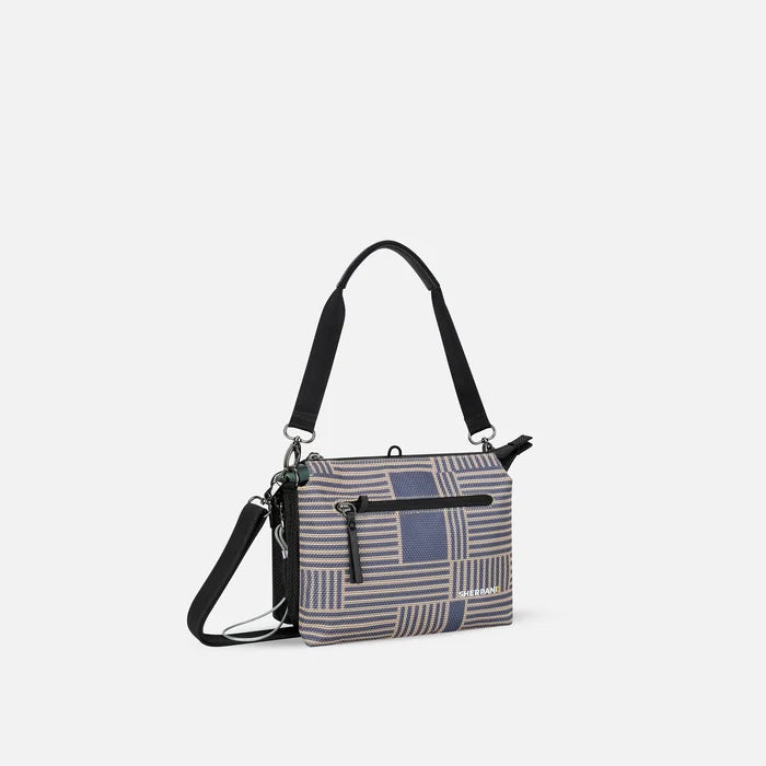 A Sherpani Mei Passport Anti-theft Travel Trio Crossbody, 3/4 view showing three main pockets on white backdrop.  #color_passport-print