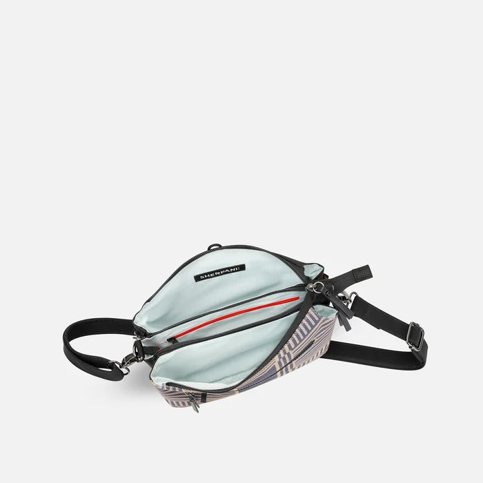 A Sherpani Mei Passport Anti-theft Travel Trio Crossbody, above view showing inside three main pockets white backdrop.   #color_passport-print