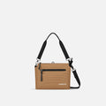 A Sherpani Mei Sand Anti-theft Travel Trio Crossbody, front view showing lockable pockets on white backdrop.   #color_sand-tan