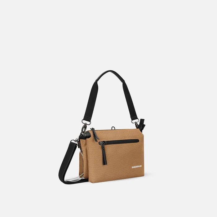 A Sherpani Mei Sand Anti-theft Travel Trio Crossbody, 3/4 view showing three main pockets on white backdrop.  #color_sand-tan