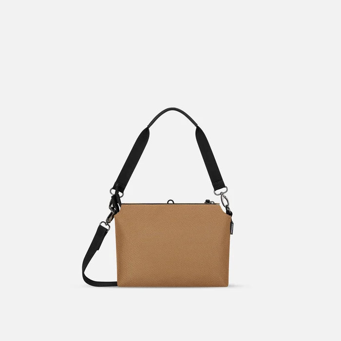 A Sherpani Mei Sand Anti-theft Travel Trio Crossbody, back view showing strap options on white backdrop.  #color_sand-tan