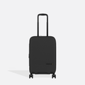 A Sherpani Meridian Black Carry-On Luggage, front view showing handle and zipper extender on white backdrop.  #color_black
