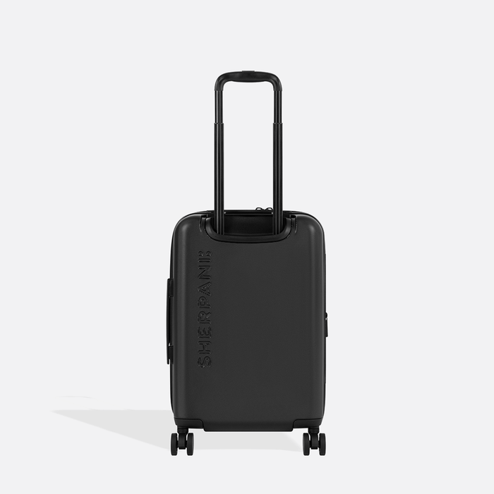 A Sherpani Meridian Black Carry-On Luggage, back view showing handle and Sherpani logo on white backdrop. #color_black